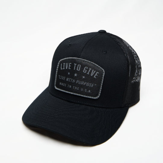 Live to Give Blackout Trucker Hat